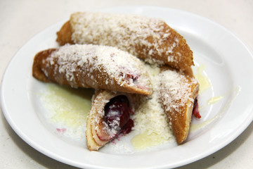 pancakes with cherry and jam on plate