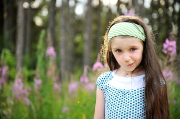 Outdoors portrait of adorable amazed blue-eyed child girl