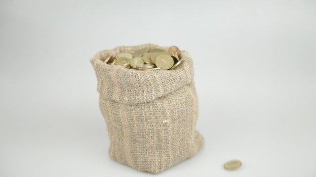 Golden coins fall from above and fill a linen bag