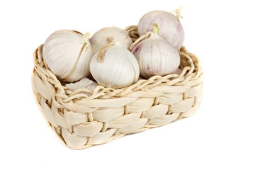 Several garlic onions in a basket isolated