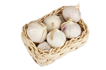 Several garlic onions in a basket isolated