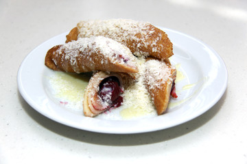 pancakes with cherry and jam on plate