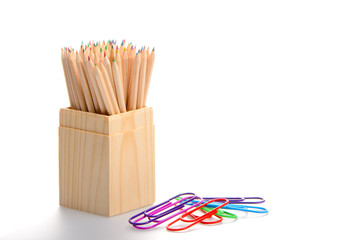 Box of coloured pencils and clips. Back to school