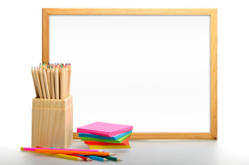 Fototapeta premium Box of coloured pencils. Back to school blackboard