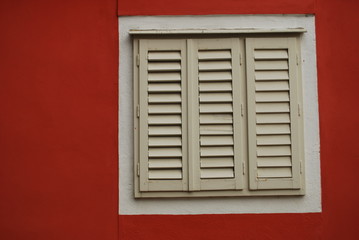 closed window closeup on red wall
