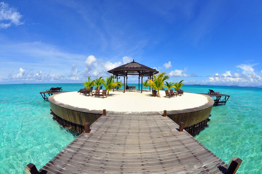 A man-made walkway Kapalai island with exotic tropical resort