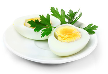 boiled egg and parsley on plate isolated on white