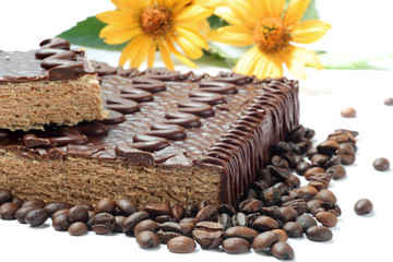 chocolaty  cake and coffee beans close up.