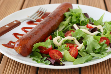 Fried sausage with salad