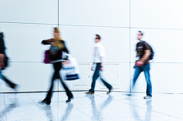 blurred people walking by