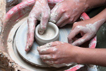 Teacher and student at pottery wheel