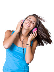 Cute young woman with headphones dancing on music