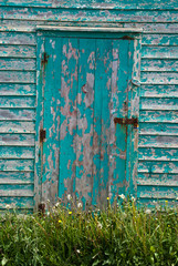 Closeup of an old blue-doored fishing shed