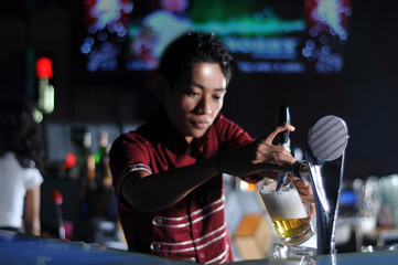 bartender pouring draught beer