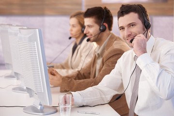 Cheerful customer servicer working in call center
