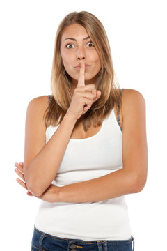 Young emotional woman with finger on lips