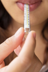 young woman checking temperature