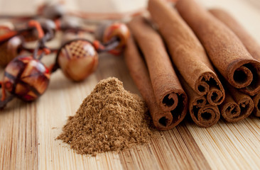 cinnamon sticks with ground cinnamon and beads