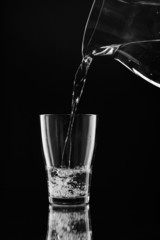 Water pitcher pouring a glass of fresh water