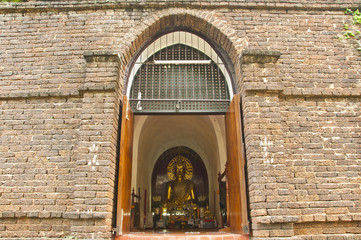 Golden Buddha in brick arch..
