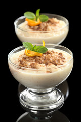 Rice pudding with cinnamon, orange peel and mint leaf