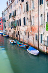 Fototapeta na wymiar parked boats on canal in Venice, Italy