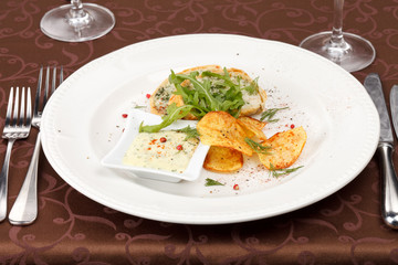 fish pie with sauce and potato chips