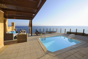 Terrace with a swimming pool in front of the sea
