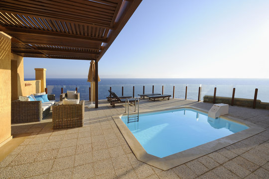 Terrace with a swimming pool in front of the sea
