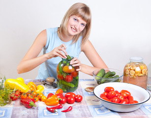 A young woman chops salad