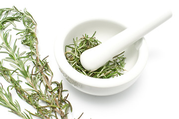 White ceramic mortar and pestle with rosemary