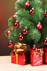 beautiful Christmas tree and gifts on wooden table
