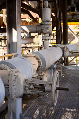 Fototapeta na wymiar Steam pipe valves and service platform in plant