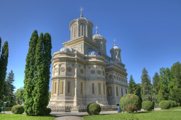 Fototapeta na wymiar Green park around a beautiful orthodox monastery