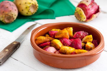 Sliced Indian Figs in a Bowl on White Wood