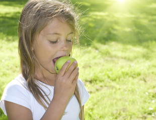 Little girl eating apple