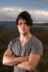 Young male on a windy cliff top