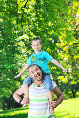 Fototapeta na wymiar happy father and son have fun at park