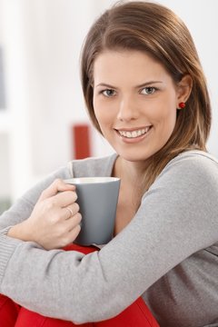 Cheerful woman with coffee cup