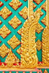 Golden Thai pattern design on temple pillar