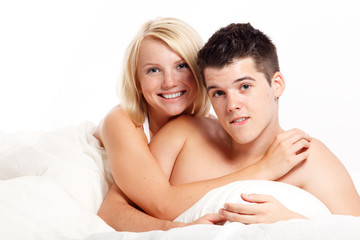 Loving affectionate heterosexual couple on bed.