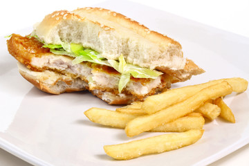 Half eaten chicken burger with chips on the plate