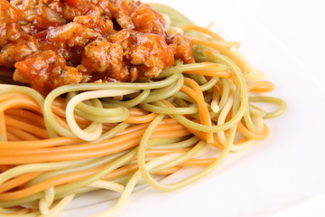 Colorful Spaghetti bolognese on a plate in close up