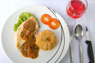 Chicken steak with fried rice and pink wine