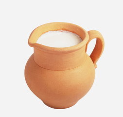 Milk in a clay jug and cheese