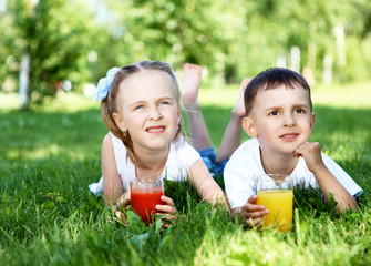 Little brother and sister in summer park