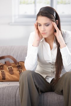 Young woman having headache after work