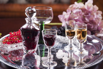 glass of cordial with carafe and hydrangea