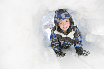 Young boy playing in the snow