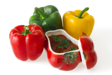 Colorful bell peppers with red ceramic ornament isolated